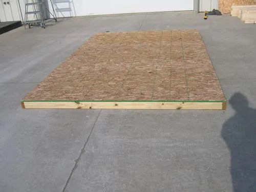 an image of the optional floor kit for Little Cottage Co storage sheds. The floor kit is placed on the ground and is ready for assembly.