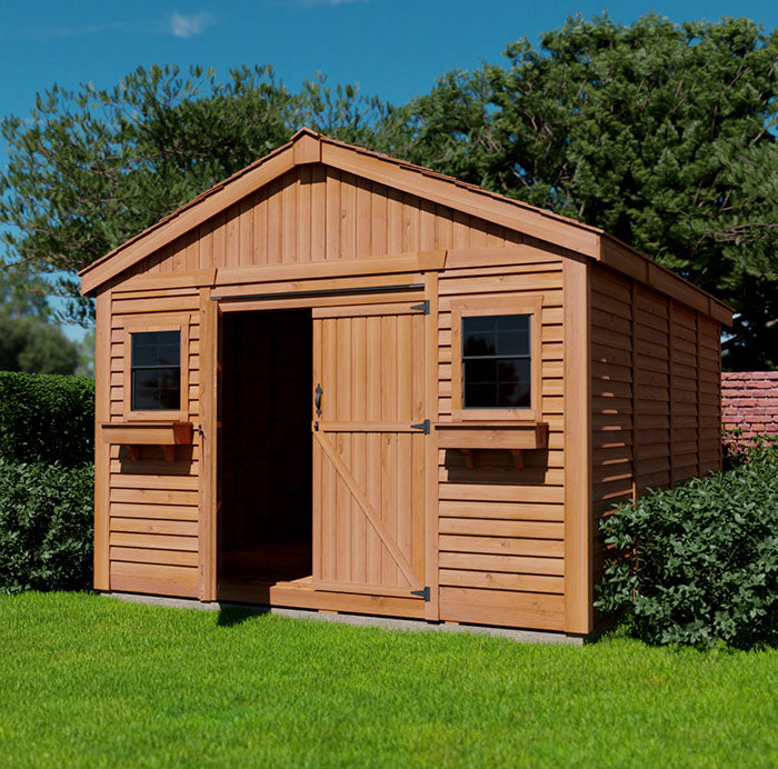 Western Red Cedar Space Master storage shed with double doors, two windows, and flower boxes, assembled on a grassy lawn.