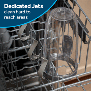 A dirty blender cup is being placed onto one of the dedicated wash jets.