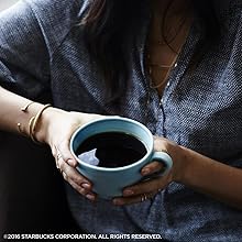 A better cup of coffee from Starbucks held in hands