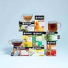 eight stacked boxes of stash tea sitting on a table with brewed cups of tea