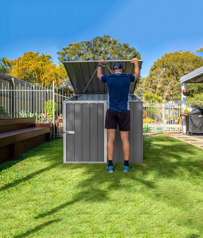 A man opening the Absco AB1070 Multipurpose Metal Pool Pump Shed 5 x 5 ft.
