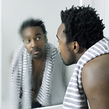 Man looking into a mirror