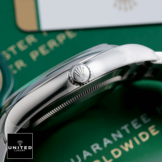 Rolex Perpetual 114300 Replica 6 Rolex Datejust Perpetual 114300 Stainless Steel Case & Crown Pusher Replica Right Side on the table