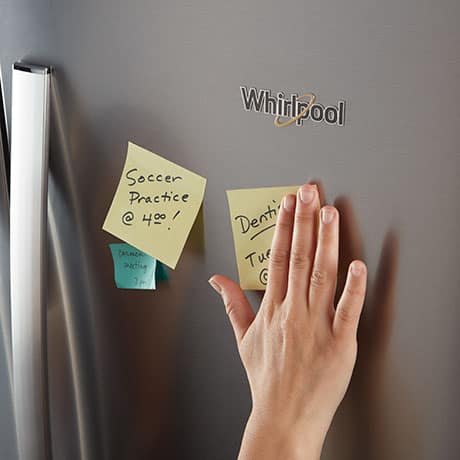 Front of the refrigerator with reminder notes stuck to it. Front of the refrigerator with reminder notes stuck to it.