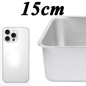 White smartphone with triple camera next to a white container, scale shows 15cm.