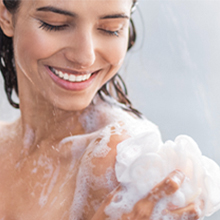 A woman using Dove Beauty Beauty Bar