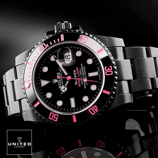 Rolex Blaken Submariner Pink Bezel and Black Dial on the table