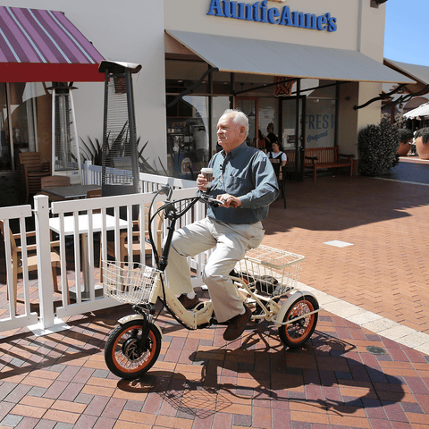 Elderly_Holding_a_Cup_of_Coffee_While_Riding_a_Transit_750W_Folding_Electric_Trike