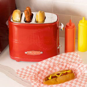 Red long slot toaster with 2 hot dogs ad 2 buns inside and one with mustard on red checkered paper