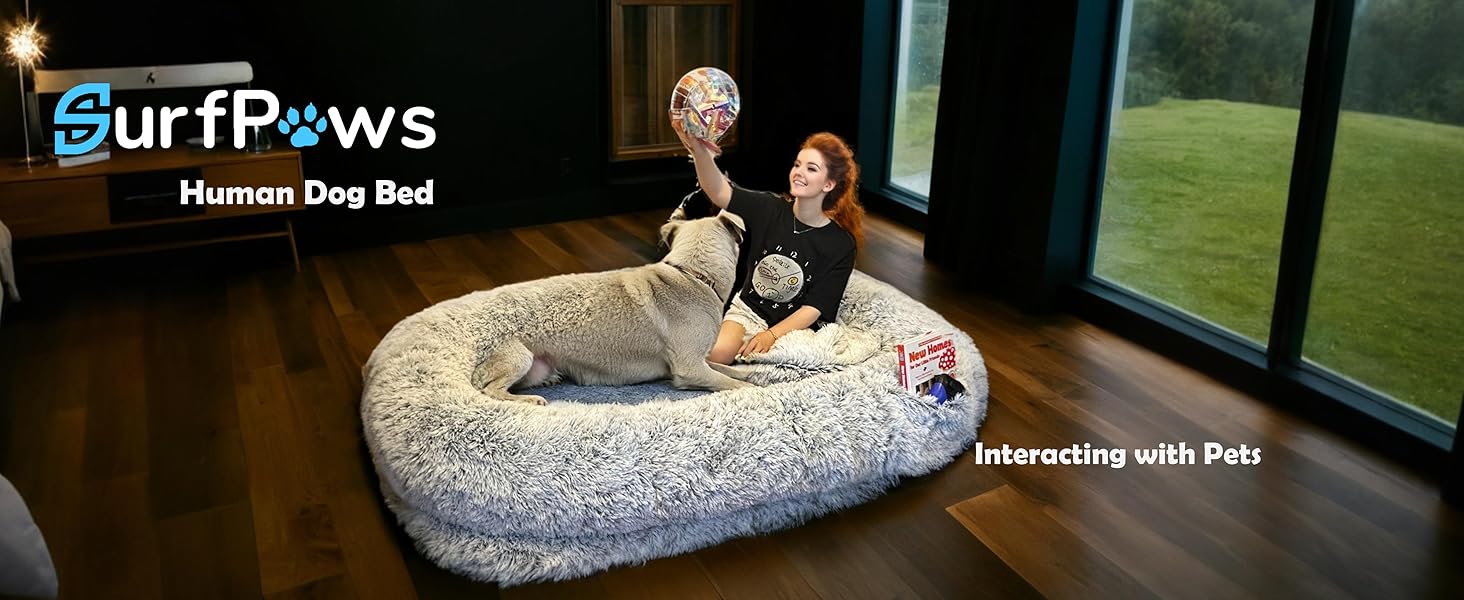 Woman interacting with her dog on the Surfpaws Human Dog Bed, sharing bonding time