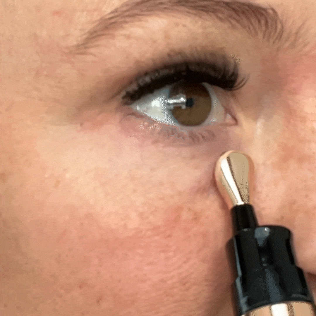 a person applying makeup on their face