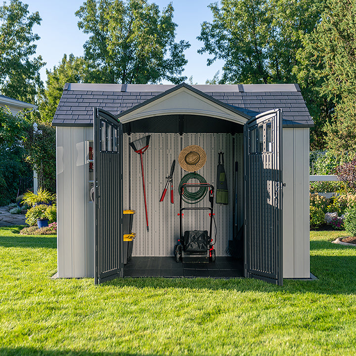 Front view of the Lifetime Shed Classic 10 x 8 with open doors, displaying various gardening tools and equipment stored inside.