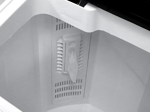 Closeup of the removable lint filter inside the Kenmore twin tub laundry machine 