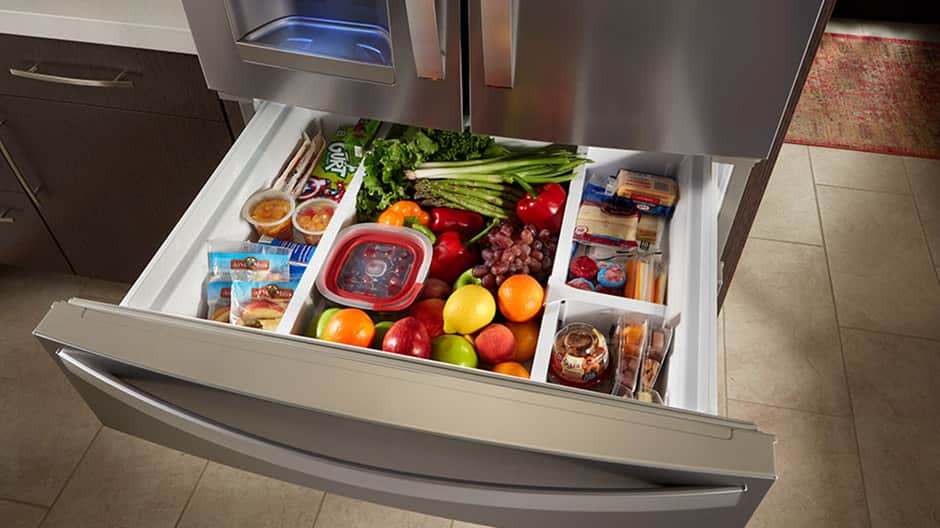 Fully extended refrigerator drawer filled with fruits, vegetables and snacks. Fully extended refrigerator drawer filled with fruits, vegetables and snacks.