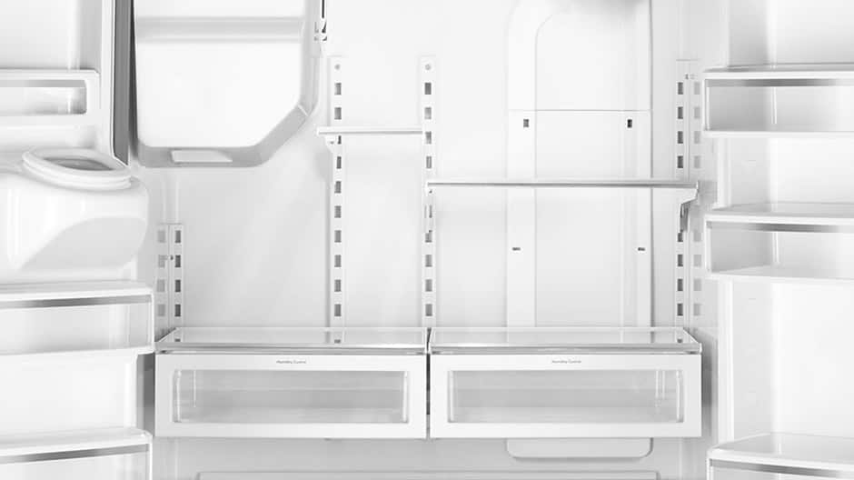 Empty interior of the refrigerator showing many movable shelves and door bins. Empty interior of the refrigerator showing many movable shelves and door bins.