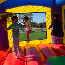Kids Bouncing in a Hero Kiddo Bounce Castle