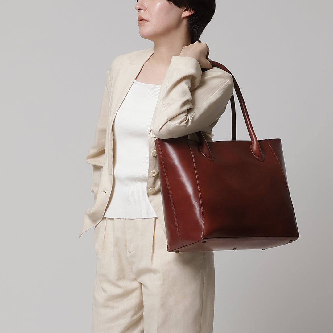 Image of a woman carrying an Antique Career Tote on her shoulder
