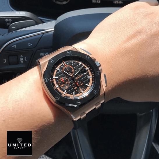 Rose Gold AP Watch Replica audemarspiguet royaloakoffshore 26401RO.OO .A002CA.02 hand 1 Audemars Piguet Black Bezel Replica on the steering wheel on a man's wrist