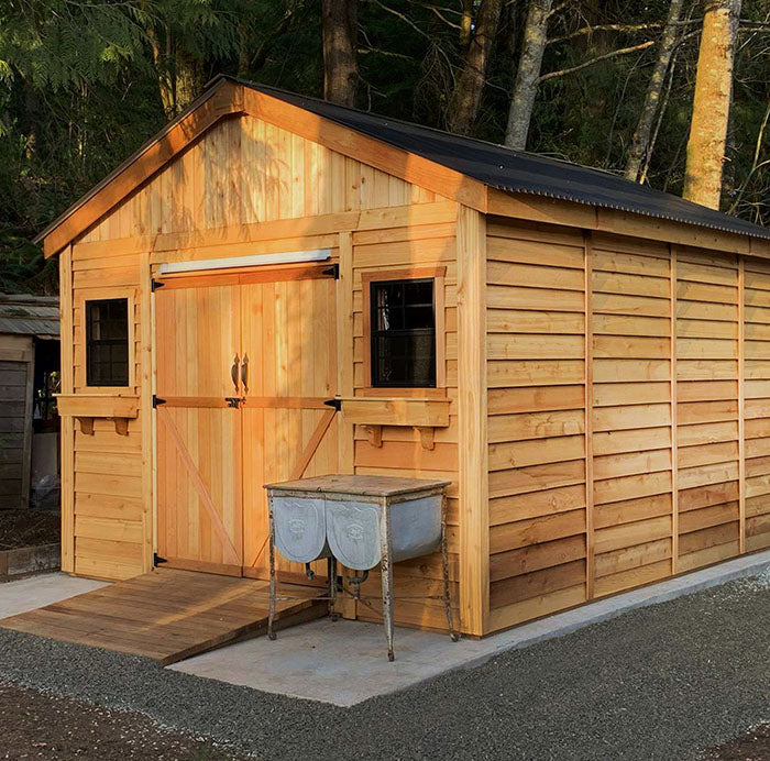 Large wooden outdoor storage shed with double doors, two windows, and a ramp, made from Western Red Cedar.