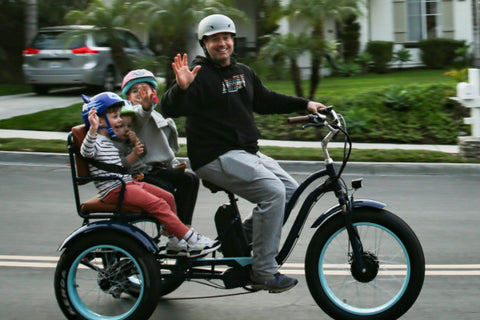 EVRYjourney 750w Electric Tricycle Rickshaw with roomy passenger seat, ideal for family rides, showcasing two kids waving while being driven.