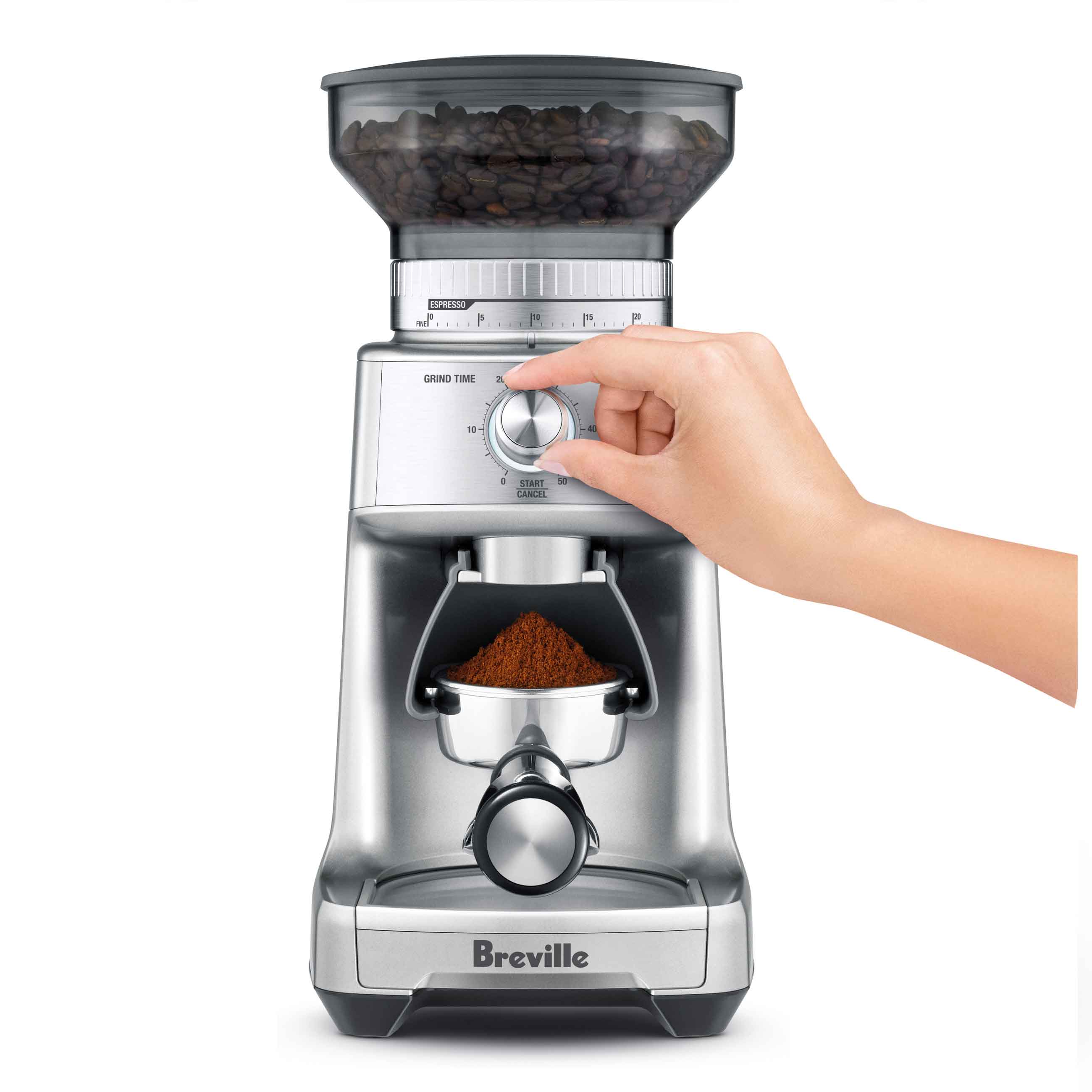 User selecting grind size using the setting wheel.