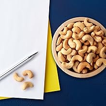 Cashew bowl and pen on blue background