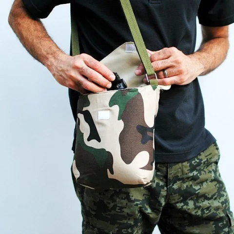 male model open a camouflaged bag