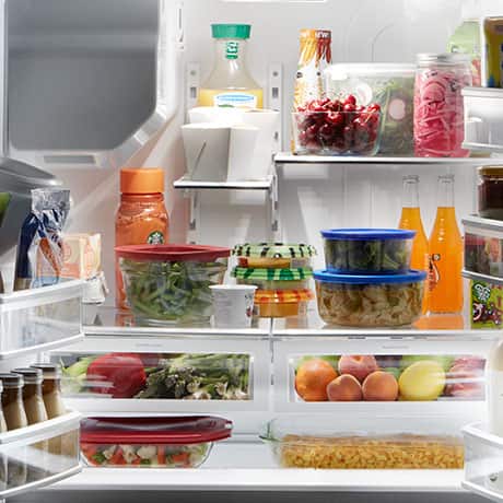 Interior of loaded refrigerator with all items fully lit. Interior of loaded refrigerator with all items fully lit.