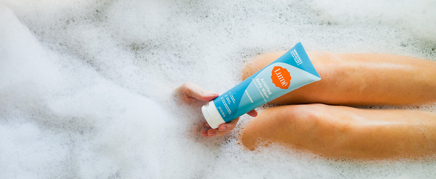 Lumē Acidified Body Wash in Unscented being used in a bath tub