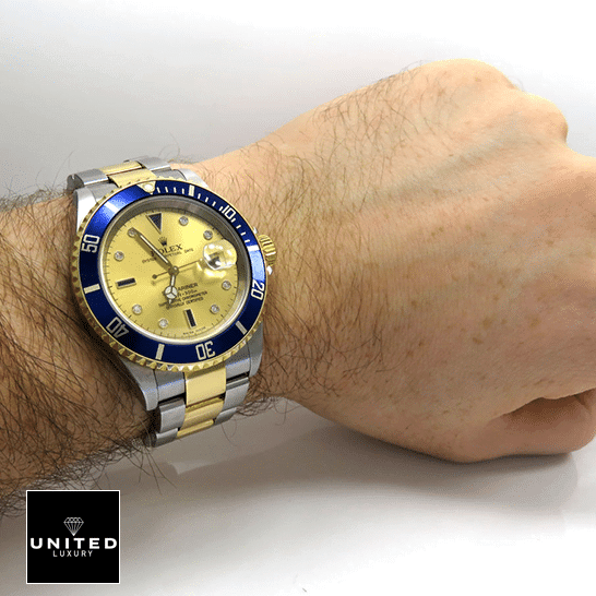 Rolex Submariner Serti Two Tone Stainless Steel Gold Diamond 16613 Replica 3 Rolex Submariner 16613 Two Tone Stainless Steel Gold Diamond Dial Replica on his arm