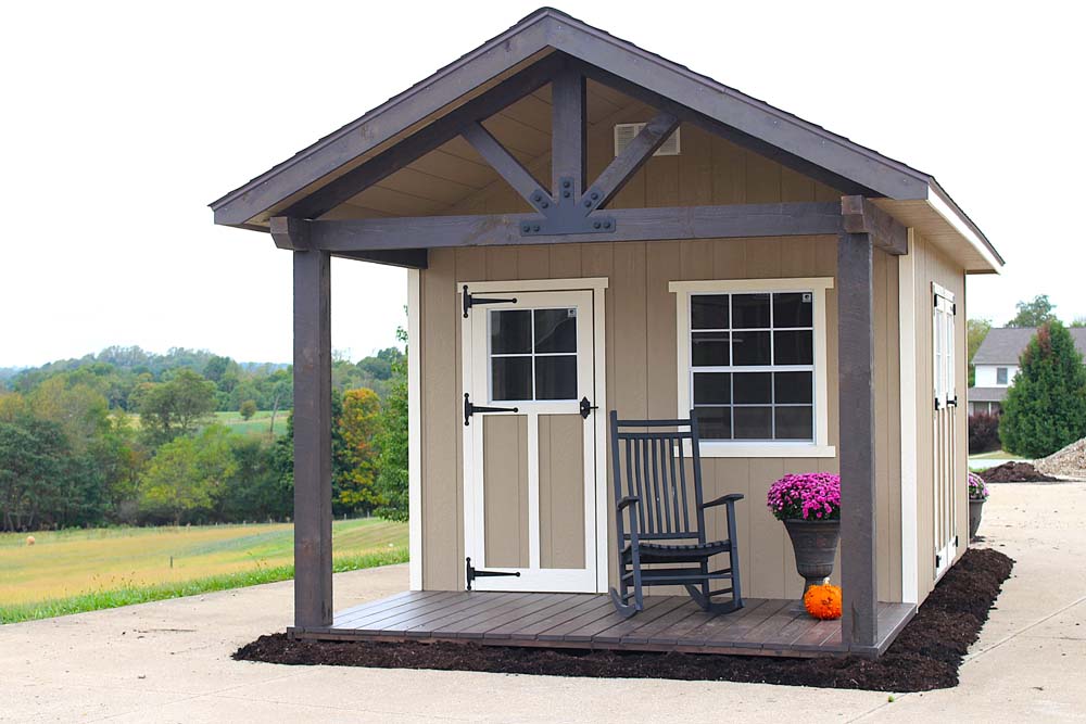a woodsman shed kit with a charming porch and a rocking chair