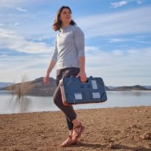 woman carrying camp chef kodiak camp stove