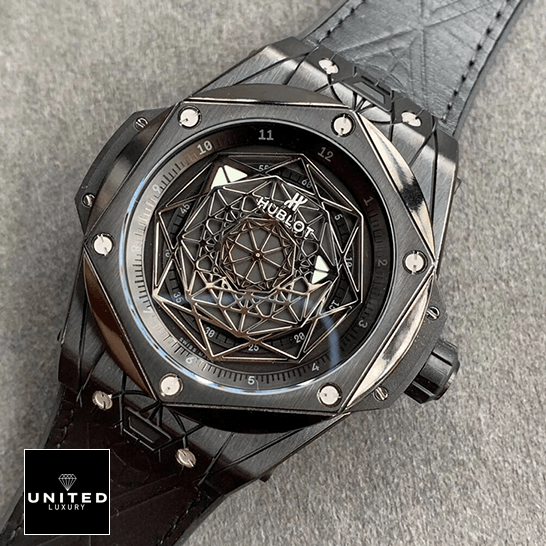 Hublot All Black Replica hublot big bang sang bleu all black left Hublot Big Bang All Black Leather Bracelet Replica on the grey carpet