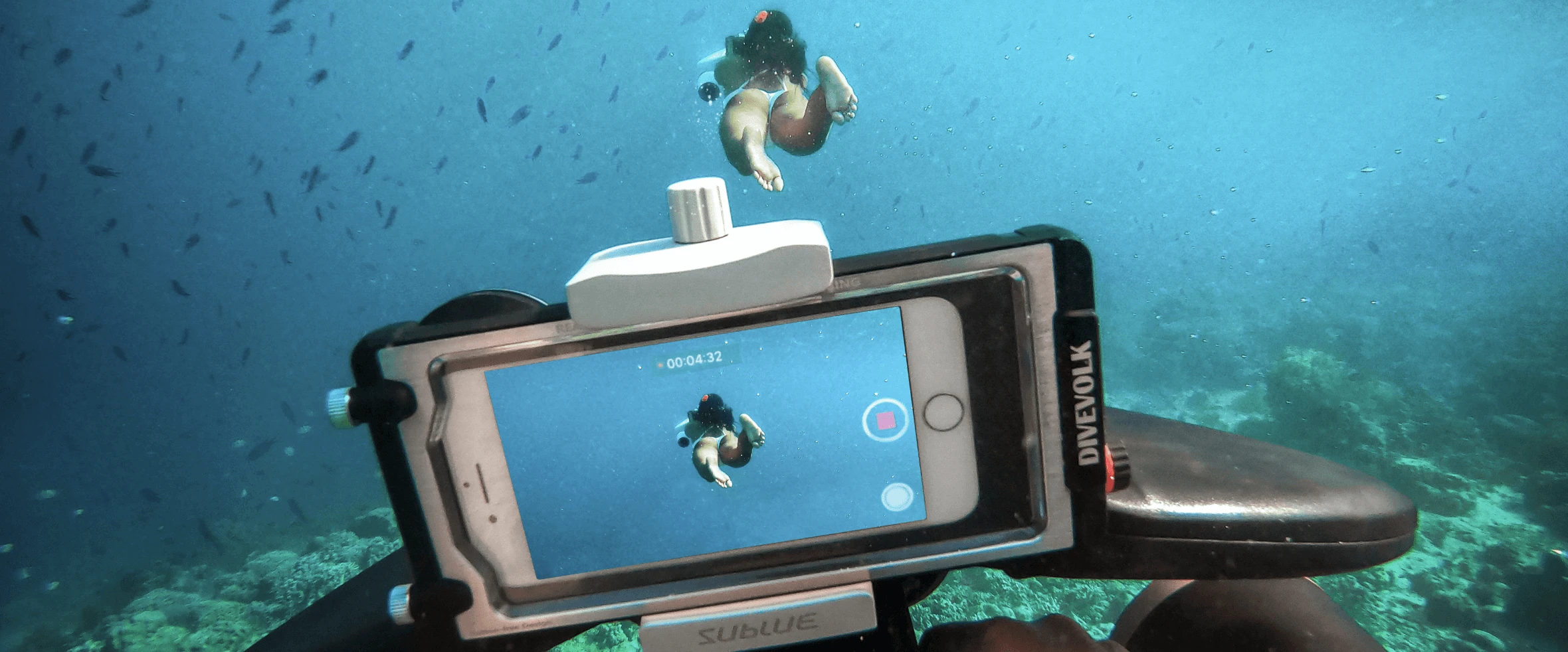 a person swimming underwater with a camera