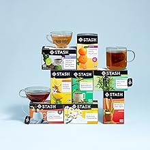 eight stacked boxes of stash tea sitting on a table with brewed cups of tea