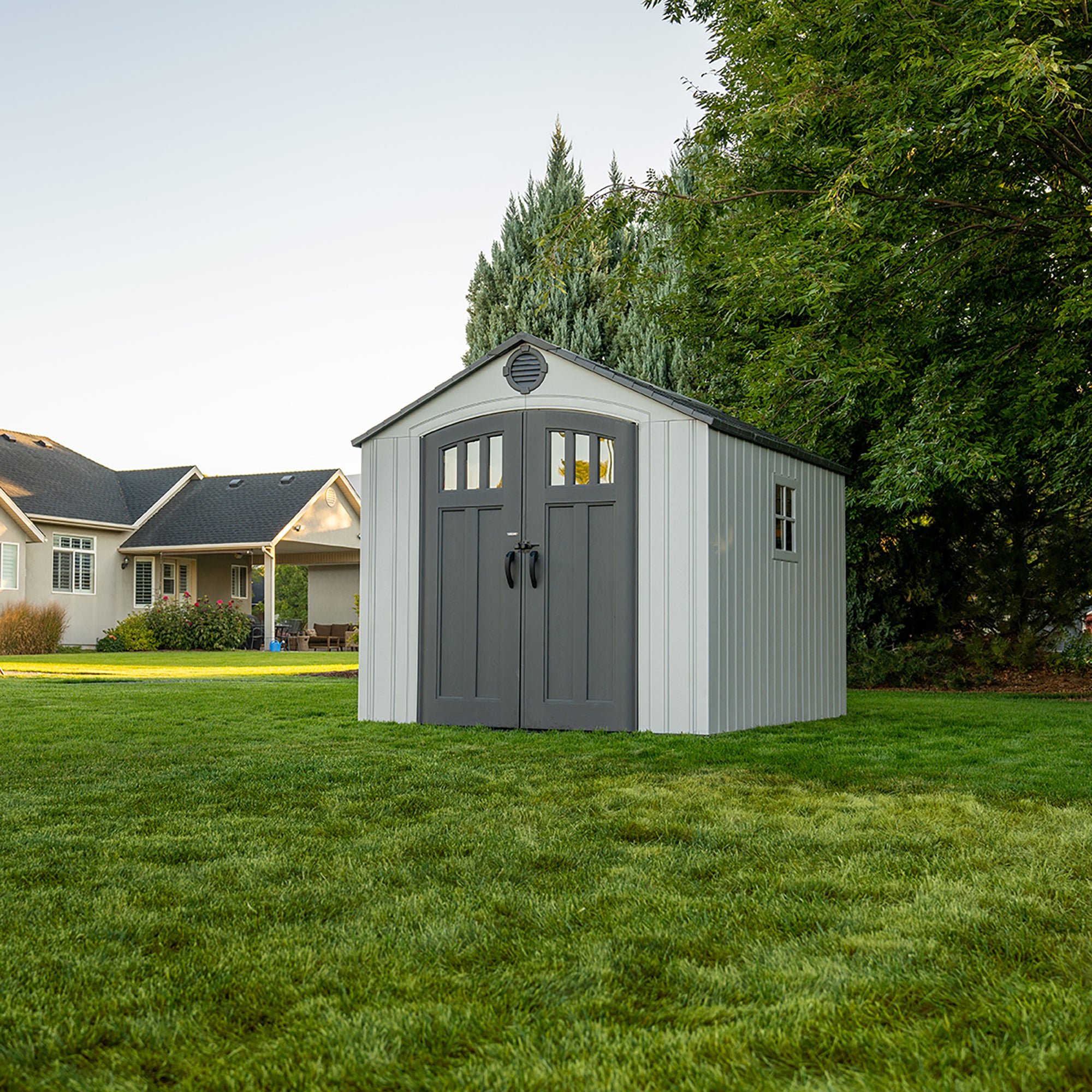 Closed view of a Lifetime 8x10 Shed in a garden, illustrating the shed
