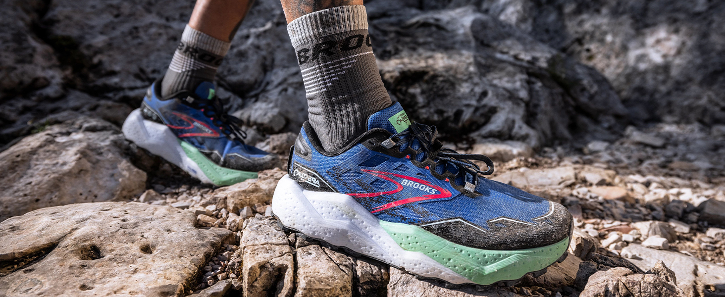 close up of dirty trail shoe on rocky terrain