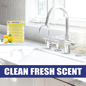 Clean kitchen with white tiles and sun shining through the window. Yellow packaging with lemons.