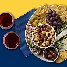 charcuterie tray with mixed nuts, grapes, olives, cheese, crackers