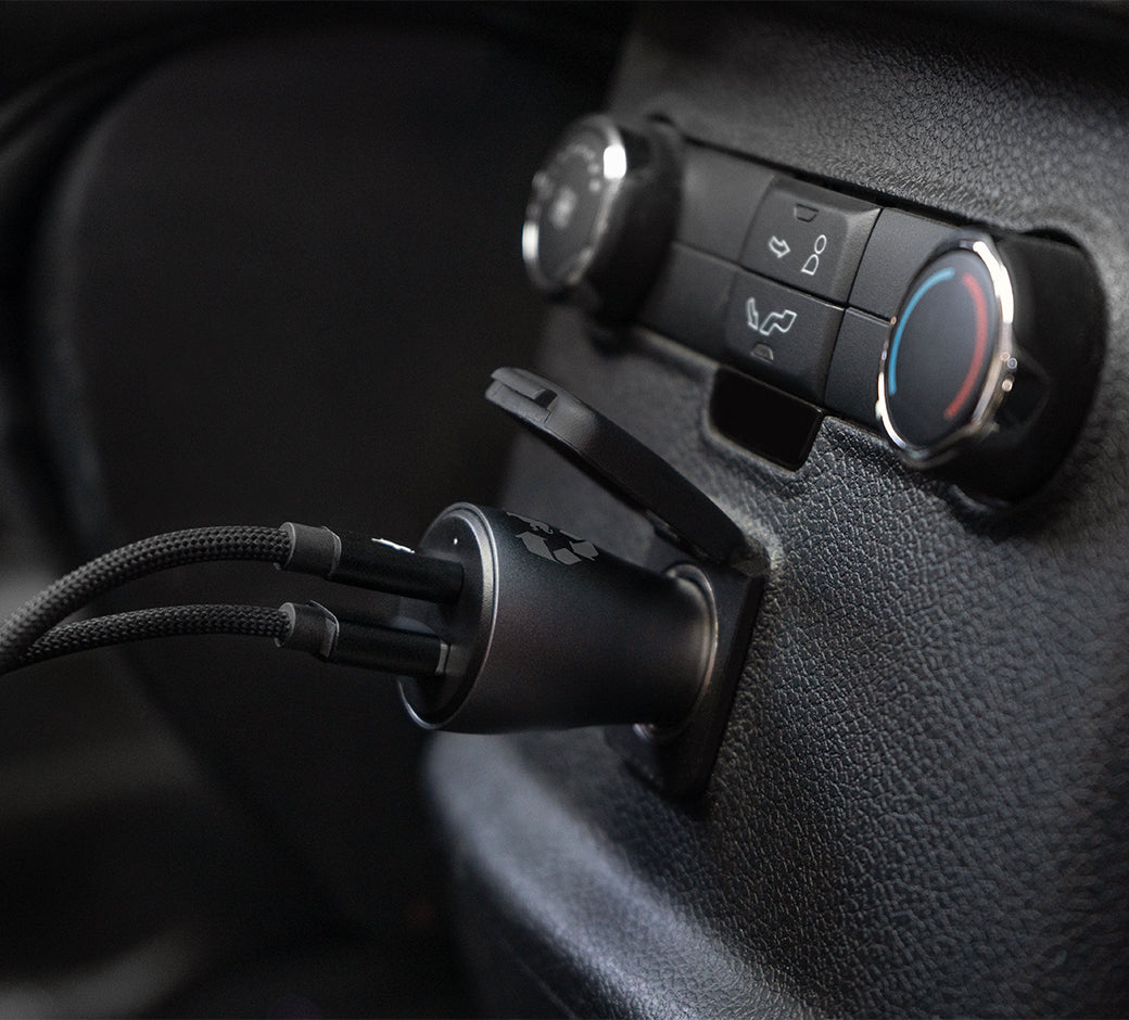 Car charger with two cables plugged into a car socket.