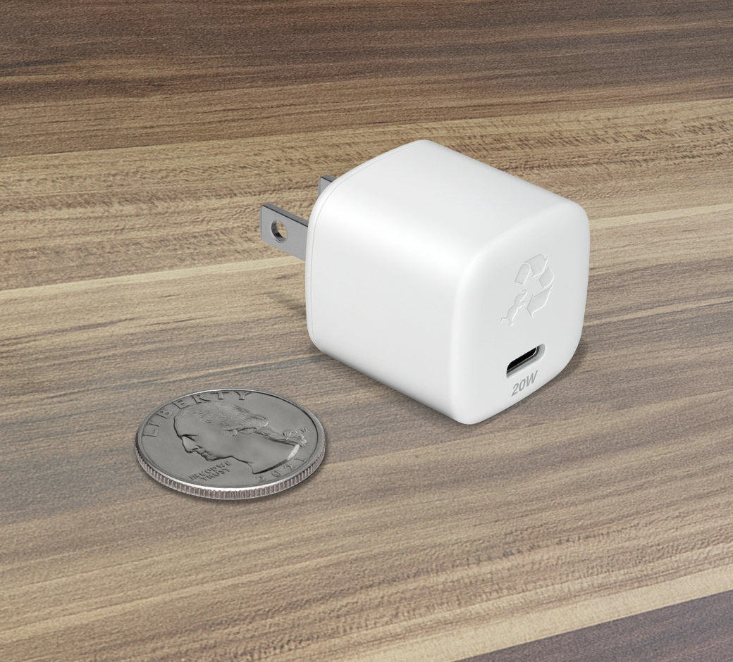 White 30W USB-C wall charger next to a quarter, showcasing the compact design.