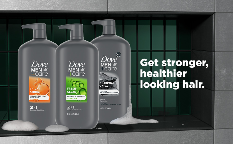 A product shot showing  3 pump bottles of Dove Men+Care variants dripping lather.