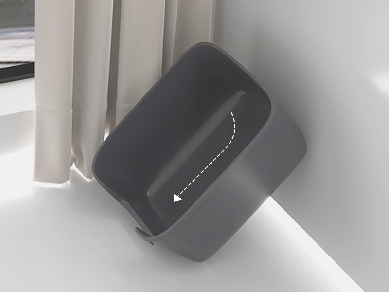 Gray rectangular device with curved edges mounted on wall corner. Features a slot opening with downward-pointing arrow, suggesting a sliding or insertion function.