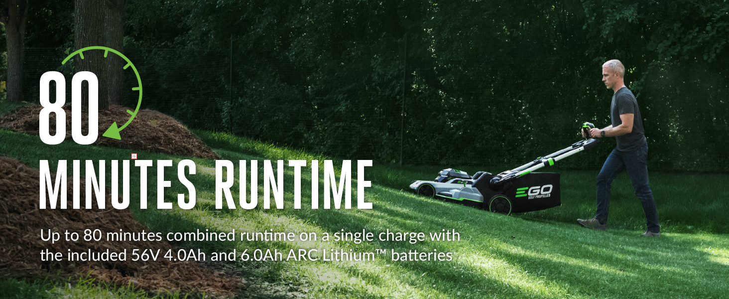 man pushing mower up a hill on partially cut yard to show 80 minute run time of mower