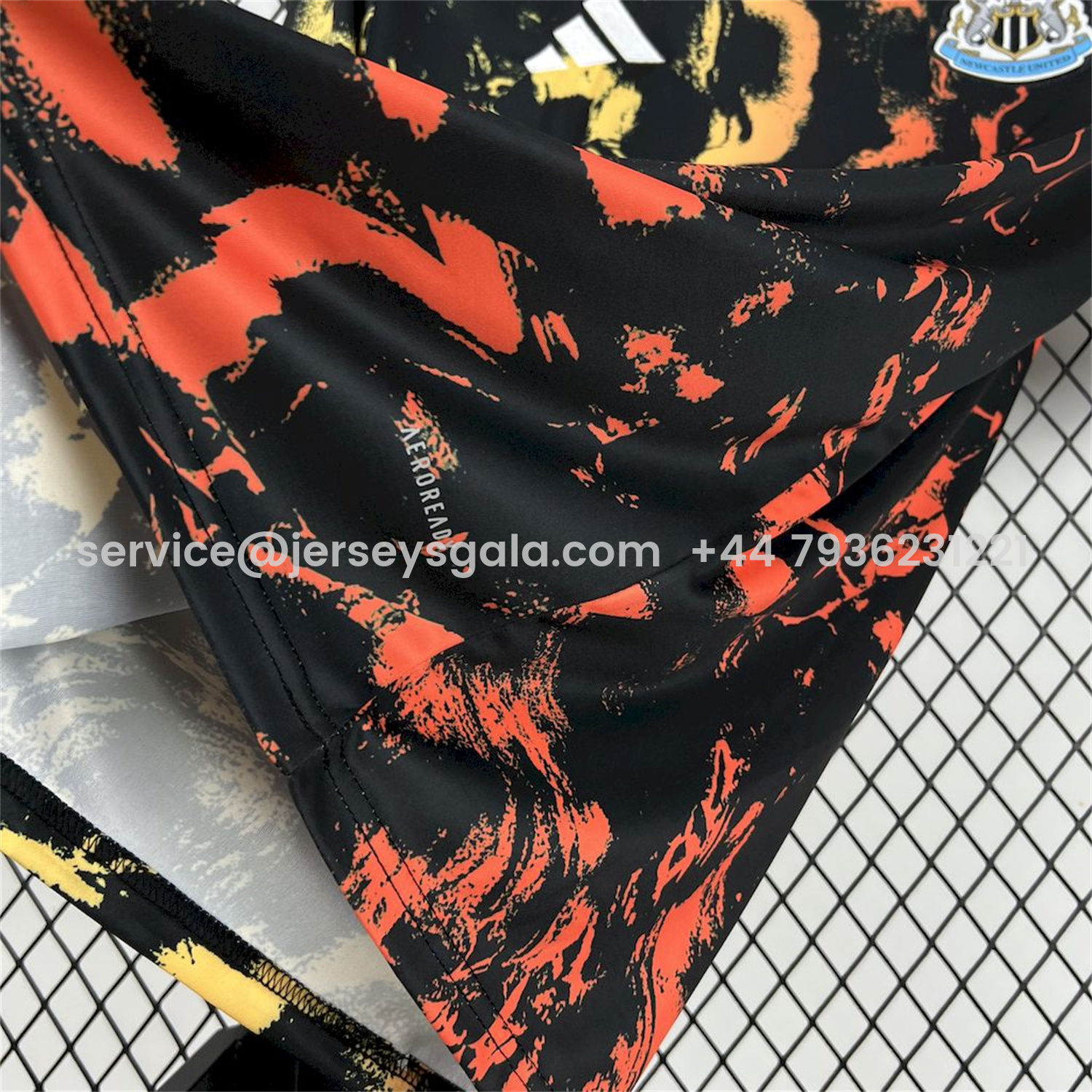 JerseysGala.com | Newcastle United 25-26 Orange Red Graffiti Black Pre-Match Training Jersey - Fans Version -Customize Name, Number and Patch | Worldwide Shipping